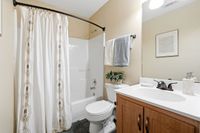 Inviting bathroom with elegant shower curtain, modern fixtures, and stylish vanity with ample storage.