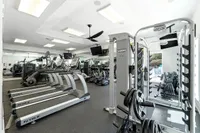 Modern fitness center featuring state-of-the-art equipment, including treadmills, weight machines, and a sleek contemporary design.