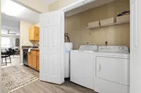 Spacious apartment with in-unit laundry and modern kitchen seamlessly connected to a bright, inviting living area.