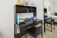 Contemporary workspace featuring a sleek black desk with ample shelving, ideal for productivity and style.