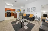 Inviting open-concept living area featuring a modern kitchen, stylish seating, and contemporary decor for a chic and comfortable lifestyle.