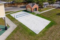 Inviting sand volleyball court set beside a charming brick building, perfect for outdoor recreation and relaxation.