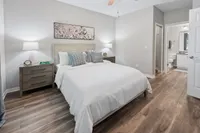 Inviting bedroom with elegant decor, featuring a plush bed, stylish nightstands, and modern ensuite bathroom.