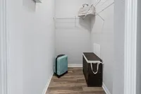 Bright and spacious closet with sleek wooden flooring and ample storage space, ideal for an organized lifestyle.