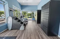 Bright and modern fitness area with state-of-the-art equipment, large windows, and scenic views.