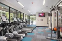 Spacious fitness center with modern treadmills overlooking a scenic view, ideal for an energizing workout experience.