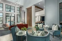 Inviting modern lounge space with plush seating, stylish decor, and large windows offering natural light.
