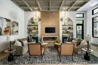 Elegant living room with modern decor, featuring plush sofas, stylish chandeliers, and a cozy fireplace, perfect for relaxation and entertaining.