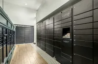 Modern package locker system in a sleek apartment building, featuring secure Luxer One lockers and elegant wood flooring.
