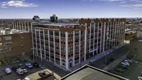 Chic urban apartment building with modern architectural design, offering panoramic city views and a vibrant downtown location.