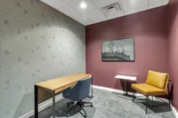 Chic home office with a contemporary desk, comfortable seating, and elegant wall art, creating a perfect work-from-home atmosphere.