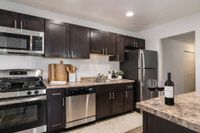 Kitchen with espresso cabinetry and stainless steel appliances