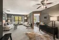 Inviting living room with modern decor and cozy ambiance, featuring plush seating, elegant lighting, and a scenic window view.