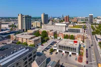 Vibrant cityscape showcasing modern apartments amidst downtown skyline, highlighting urban convenience and lively atmosphere.