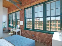 This elegant primary bedroom features sophisticated design elements and comfortable proportions for restful nights.  | Watch Factory Lofts | Watch Factory Lofts Apartments