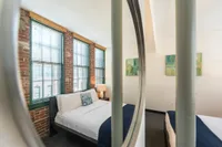 A light-filled bedroom features an open layout and contemporary details, creating an airy atmosphere for ultimate relaxation. | Watch Factory Lofts | Watch Factory Lofts Apartments