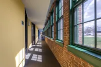 A bright and inviting hallway combines industrial architectural details with a bold, modern aesthetic throughout. | Watch Factory Lofts | Watch Factory Lofts Apartments