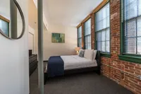 Your primary bedroom suite provides luxurious privacy with ensuite bathroom and walk-in closet convenience.  | Watch Factory Lofts | Waltham Apartments
