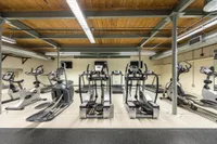Step machines in fitness center at Watch Factory Lofts apartments . | Watch Factory Lofts | Watch Factory Lofts Apartments