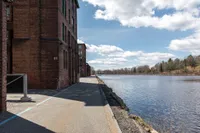 River view and walkway at Watch Factory Lofts apartments in Waltham, MA.. | Watch Factory Lofts | Watch Factory Lofts Apartments