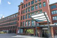 Outdoor entrance to leasing office at Watch Factory Lofts apartments in Waltham, MA.. | Watch Factory Lofts | Watch Factory Lofts Apartments