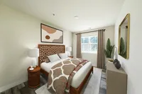 Elegant bedroom with modern decor, featuring a cozy bed, stylish artwork, and natural lighting.