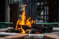 Inviting outdoor fire pit with glowing flames surrounded by rustic seating.