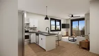 Contemporary open-plan kitchen and living room with modern furnishings and expansive windows.
