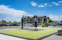 Vibrant community living featuring modern apartments with a scenic mountain backdrop and outdoor basketball court.