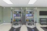 Modern exercise room featuring state-of-the-art workout equipment, vibrant weights, and sleek fitness technology.
