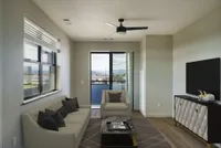 Modern living room with chic furnishings and a large window offering stunning views, perfect for relaxation and entertaining.