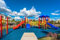 Marq Highland Park Playground View of Playground, Showing Playground Equipment, Monkey Bars, and Slides at The Marq Highland Park Apartments in Tampa
