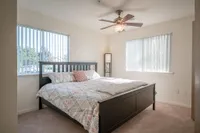 1-, 2-, and 3-Bedroom Apartments in Holland View of Furnished Bedroom, Showing Bed, Dual Windows, Ceiling Fan and Carpet at Clearview Apartments