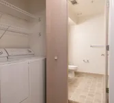 Washer and Dryer View of Attached Laundry Room, Showing Full Size Washer and Dryer, and Shelving at Clearview Apartments