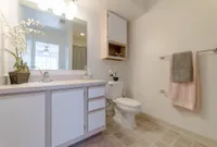 Spacious Bathroom View of Bathroom, Showing Single Vanity, Large Mirror, Storage, and Tile Flooring at Clearview Apartments