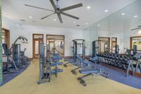 Marq Highland Park Gym View of Fitness Center, Showing Exercise Machines, Free Weights, and Benches at The Marq Highland Park Apartments in Westchase Tampa