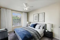 View of Enclave on Golden Triangle Bedroom with Bed, Side Tables, Lamps and a Large Window