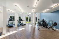 Experience workout sessions in this sleek and airy gym space designed for your fitness needs at 805 Riverfront Apartments in Sacramento