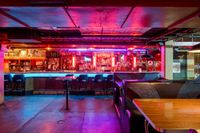 The Billiards Bar Near The Melrose Apartments Colorful and inviting bar interior with neon lights and comfortable seating.