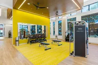 State-of-the-Art Fitness Center View of Sugarmont Gym Showing Free Weights, Workout Benches, and Cable Machine with Yellow and Wood Flooring and Ceiling
