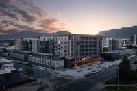 Sugarmont Apartments in Sugar House View of Sugarmont Apartmetns, a modern urban apartment complex at sunset with stunning Wasatch mountain backdrop, showcasing a vibrant community living experience in Sugar House.