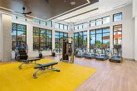 State-of-the-Art Fitness Center View of Sugarmont Gym Showing Stairmaster, Workout Benches, Treadmills, Cable Machine, and Yellow and Wood Floor and Large Bay Windows