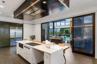 Clubroom with Kitchen Modern open kitchen in Sugarmont Apartment's Clubroom with sleek island, overlooking a spacious living area and scenic pool view.