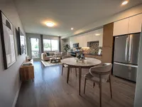 Spacious Floor Plans Chic apartment interior at Sugarmont Apartments in SLC with an open-concept layout, featuring a modern kitchen, elegant dining area, and cozy living room with natural light.