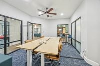 Private Conference Room at Apt CoWork at Toscana at Valley Ridge Modern conference room space with sleek glass partitions, adjustable desks, and stylish seating, perfect for dynamic work environments at Apt CoWork at Toscana at Valley Ridge Apartments in Lewisville Texas