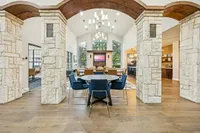 Community-Style Coworking Space Elegant coworking space with stone archways, modern seating, and natural light flooding through large windows at Apt CoWork at Toscana at Valley Ridge Apartments in Lewisville