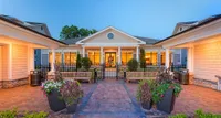 Heights at Meridian, Located in South Durham Charming apartment complex entrance, Heights at Meridian, with elegant architecture, glowing warm lights, and vibrant landscaped greenery, creating a welcoming and luxurious ambiance.