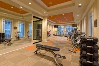 24-Hour Fitness Center Spacious modern fitness center at Heights at Meridian Apartments with state-of-the-art gym equipment and natural light.