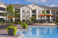 Resort-Style Pool at Heights at Meridian Luxurious apartment complex, Heights at Meridian, featuring modern architecture, a sparkling swimming pool, and beautiful outdoor seating areas.