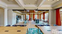 Work from Home in Durham, NC Modern co-working space at Heights at Meridian Apartments with sleek glass walls, vibrant curtains, and ample natural light accentuating a sophisticated conference area.